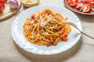Classical Italian Pasta Amatriciana on a rustic background