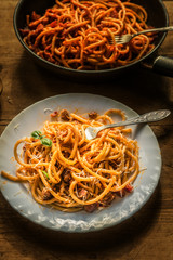 Traditional Italian Pasta Amatriciana on a rustic dark background