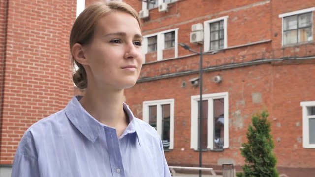 Young Casual Woman Walking on Street in Slow Motion