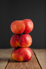 Peaches and Nectarines fruits. Concept for healthy nutrition. Dark black background and wooden table. Isolated.