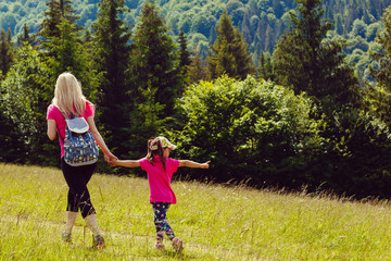 Fototapeta premium mother and little daugther hiking in mountains