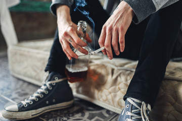 Addicted male person with cigarette and alcohol - obrazy, fototapety, plakaty