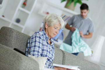 male assistant helping senior woman at home