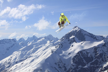 Naklejka na ściany i meble Flying skier on mountains. Extreme winter sport.