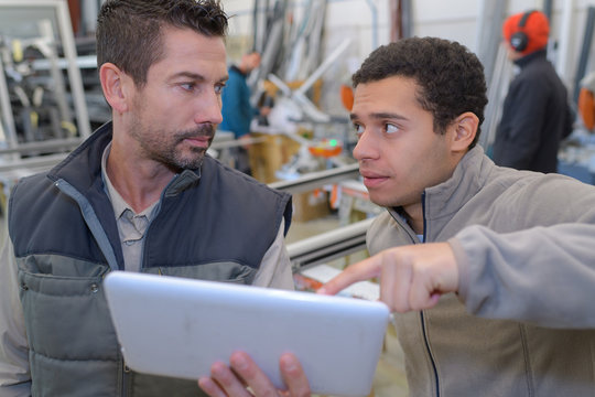 workers using digital tablet in warehouse