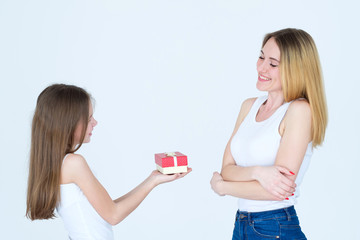reward for mothers day. little girl presents a gift to her mom. love and family bond.