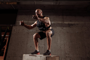 full body exercise on the wooden box at gym. rehabilitation program. close up side view...