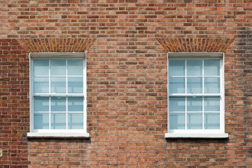 Fototapeta na wymiar Fragment of brick wall with two windows