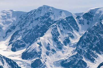 Mountain peaks covered with white shiny snow.