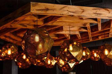 Modern style bronze decoration lamps and lampshades against dark wall.