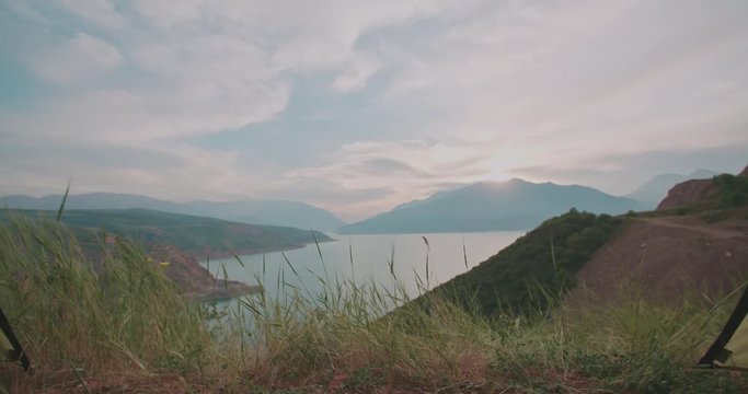 View of mountains and sky with clouds in sunset inside tent, 4k dollyshot