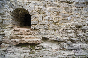 Arrowslit and limestone castle wall