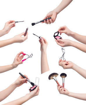 Collection of makeup cosmetics in hands on white background