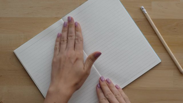 Woman hand swing clean pages in notebook