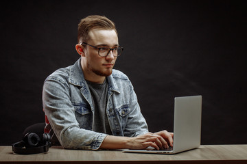calm good-looking tenager doing shopping online. look at the photos
