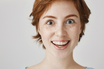 Close-up portrait of weird and funny good-looking european with ginger hair smiling like crazy and...