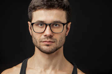 close up portrait of attractive guy with blue eyes wearing eyewear isolated. copyspace