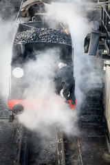 Steam train getting cleaned