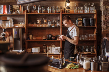a waiter is holding glass dish in the coffee bar