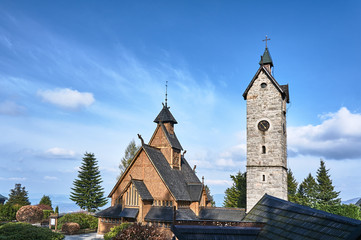 Fototapeta na wymiar Stone tower and the wooden temple Wang, Poland .