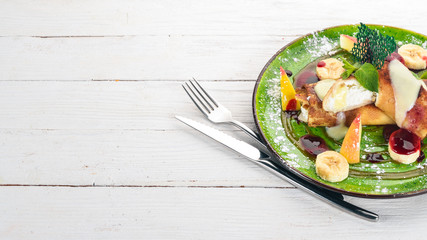 Pancakes with cottage cheese, fruit and jam. dessert. On a wooden table. Top view. Copy space.