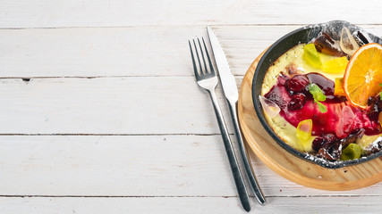 Panacotta with fruit and jam. dessert. On a wooden table. Top view. Copy space.