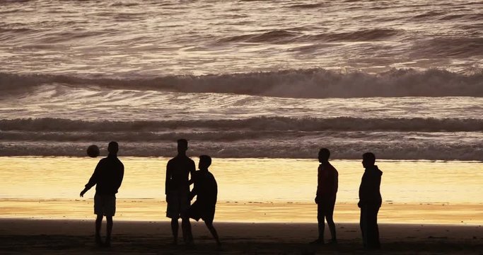 Group of People playing Football on Cabourg Beach at Sunset, Normandy, Real Time 4K