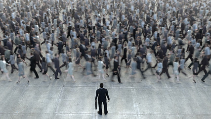 businessman standing in front of a crowd of competitors