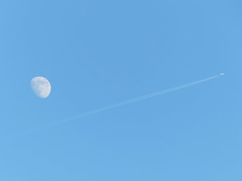 Plane flying past the moon 2