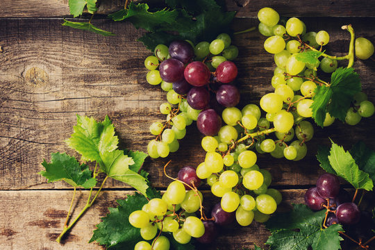 Mix grapes on vintage background. The concept of nutrition health, wine concept. Copy space, top view flat lay background.