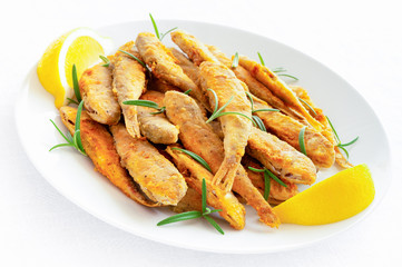 fried breaded whole goatfishes with rosemary and lemon