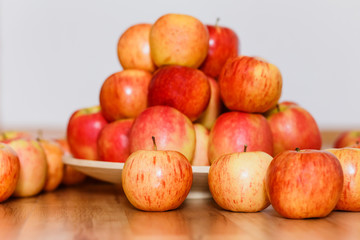 autumn harvest of ripe apples, lots of red and yellow apples on wooden background