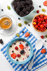 Photo of oatmeal, coffee, raspberries, strawberries, gooseberries, cherries