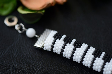 Piano keys beaded bracelet on a dark background close up