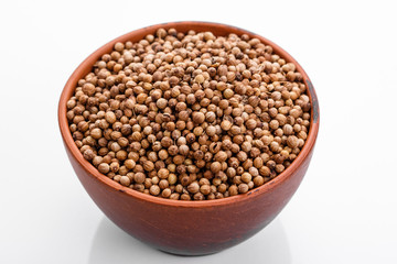 fragrant coriander seeds on a white background