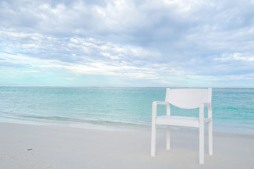Fototapeta na wymiar Summer concept , White chair on the beach white sand and turquoise sea color at maldives on the weekend holidays