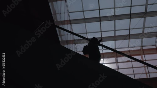 A Low Angle Of A Black Silhouette Of A Person Slowly Moving