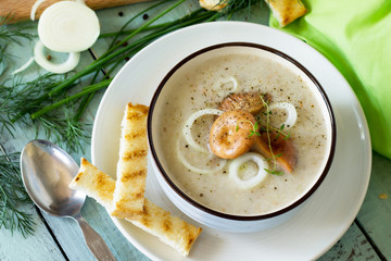 Puree soup mushrooms with croutons in a bowl on a kitchen wooden table. The concept of healthy eating. Diet menu. Copy space.