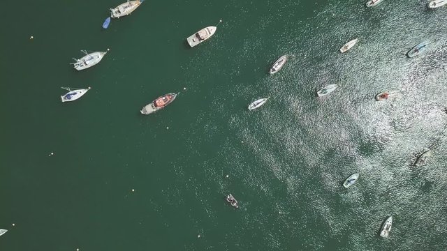 Overhead view of docked boats in Brixham England. Boats anchored off shore in ocean.