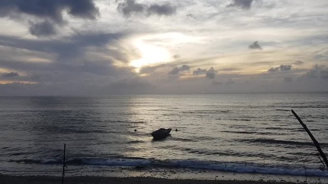 An unmanned small fishing boat roped near the shore. Shot in Batanes, Philippines.