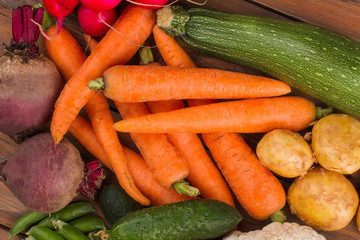 Pile of food set with vegetables. Carrots, potatoes, zucchini, beetroots, peas and radish.
