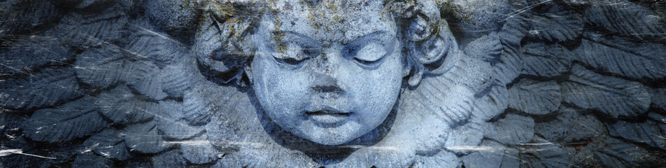 Close up of angel with wings. Vintage ancient stone statue, fragment. Retro styled.