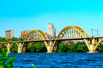 Naklejka premium Summer Landscape of the Dnepr city with a railway bridge across the Dnieper river and a view of the skyscrapers and towers of Dnepropetrovsk (Dnipropetrovsk, Dnepr), Ukraine