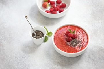 Smoothie bowl. Berrie smothie with chia seeds and raspberry topping. Super food, clean eating, plant based concept. Copy space