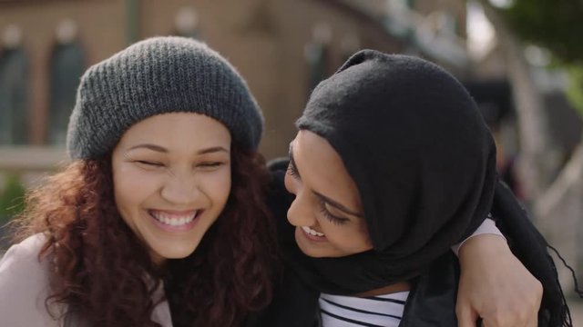 portrait of two young woman friends embrace smiling cheerful enjoying happy friendship