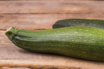 Courgette squash on wood. Close up. Old vintage wooden background.