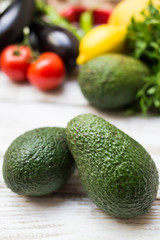 Hass avocado with summer veggies background