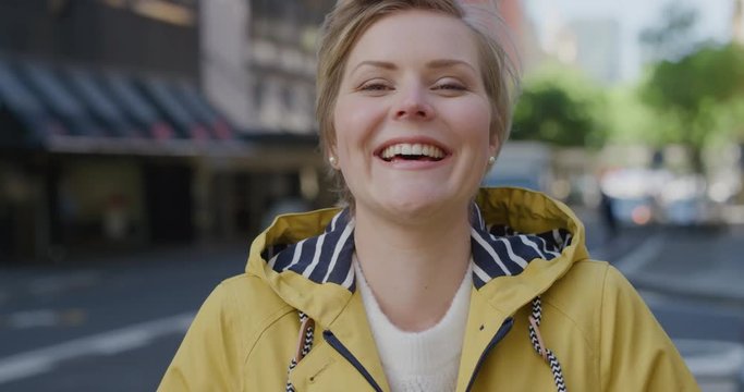 portrait of beautiful blonde woman laughing happy enjoying successful urban lifestyle cheerful caucasian female commuter in city street slow motion