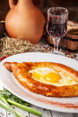 Traditional Georgian and Armenian cuisine. Khachapuri with suluguni cheese and egg yolk. background image. Copy space, selective focus