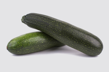Two green zucchini close up. Still life. White isolated background.